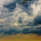 Unten Rhein, klein.  Oben Gewitterwolken, drohend. Dazwischen und etwas links von der Mitte ein fitzel­winziges Flugzeug.